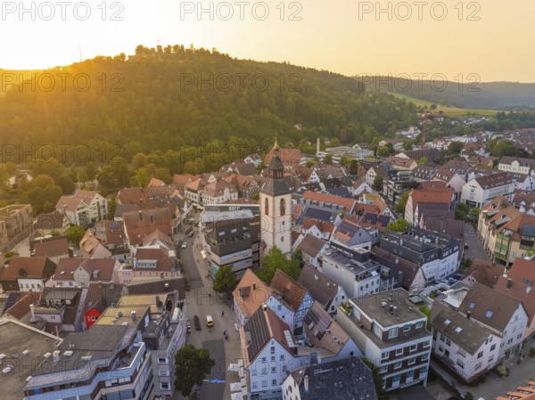 Panorama of an urban environment with a church surrounded by hills in the evening light, Nagold, district of Calw, Black Forest, Germany