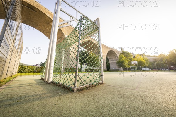 Sports field with Tor tor and bridge in the background under a clear sky, Nagold, district of Calw, Black Forest, Germany