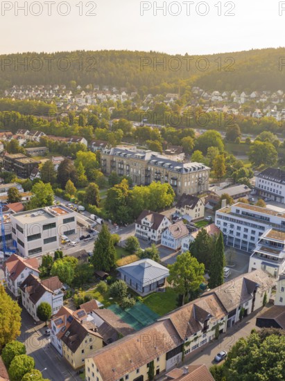 Panorama of a quiet town with green hills and numerous houses in a sunny atmosphere, Nagold, district of Calw, Black Forest, Germany