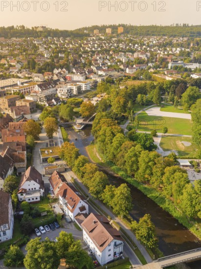 View of a town with river, surrounded by trees and green areas in autumnal splendour, Nagold, district of Calw, Black Forest, Germany