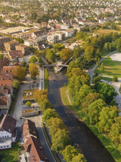River with bridges and surrounding parks and autumn trees photographed from a bird's eye view, Nagold, district of Calw, Black Forest, Germany