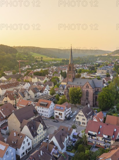 Village-like urban landscape with church and surrounding hills in the evening light, Nagold, district of Calw, Black Forest, Germany