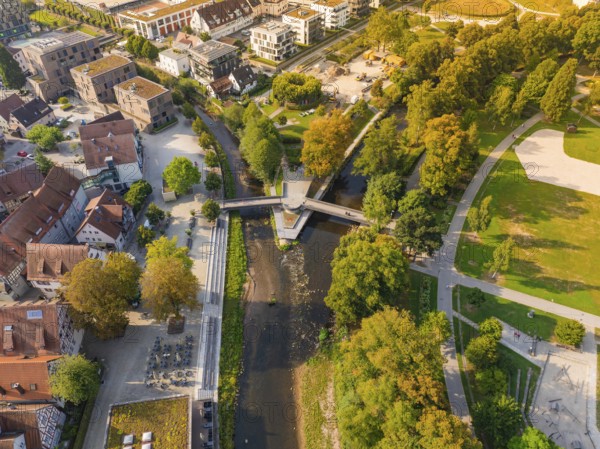 Aerial view of a park with river and bridge, surrounded by autumn leaves and buildings, Nagold, district of Calw, Black Forest, Germany