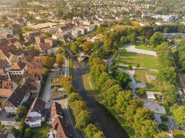 Large park and green area next to a river in the middle of an urban environment, autumnal play of colours, Nagold, district of Calw, Black Forest, Germany