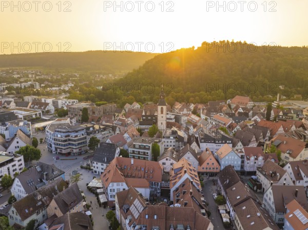 View of an old town with church and hills in the background at sunset, Nagold, district of Calw, Black Forest, Germany