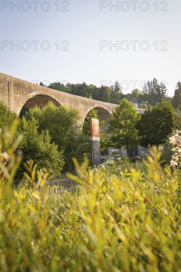 View of a bridge over an overgrown landscape in daylight, Nagold, district of Calw, Black Forest, Germany