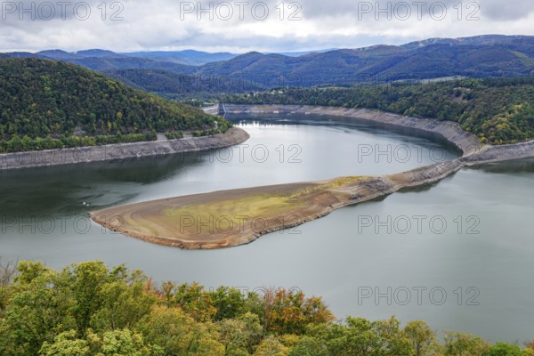 View of a dry mountain ridge below Waldeck Castle, exposed by the low water level of the reservoir, small dam wall of Edersee can be seen in the background on the left, Waldeck, North Hesse, Germany