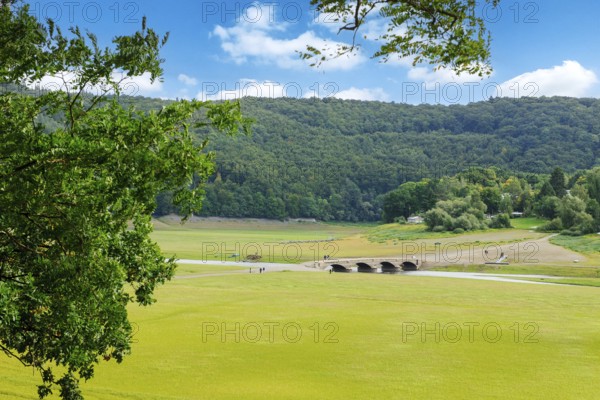 View of historic old bridge over river Eder has fallen completely dry during drought in old Eder valley near former village Alt-Asel at low water level of reservoir, Asel, Vöhl, North Hesse, Germany