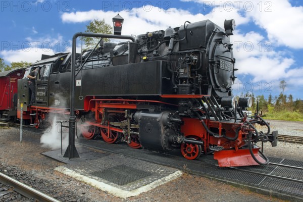 View of steam locomotive steam locomotive of Harz narrow-gauge railway narrow-gauge railway Brockenbahn standing on track towards summit of Brocken at platform of in Schierke station waiting for signal for departure, Schierke, Wernigerode im Harz, Saxony-Anhalt, Germany