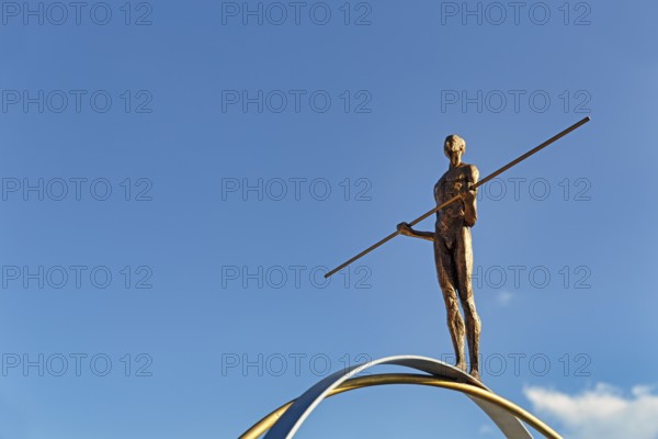 Sculpture Balance by the artist Martina Ondáková in front of a blue sky, human figure balanced, symbolic image, striving for balance and harmony, Oia, Thira, Santorini, Cyclades, Greece