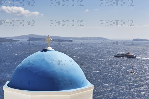 Blue dome of an orthodox church, ferry crossing the sea, Caldera, Oia, Thira, Santorini, Cyclades, Greece