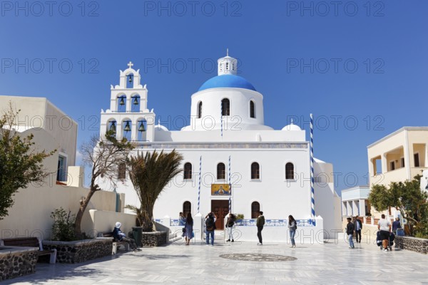 Orthodox church Panagia Platsani, whitewashed, typical blue dome, pyramid-shaped bell tower with six bells, central square in the old town, Oia, Thira, Santorini, Cyclades, Greece
