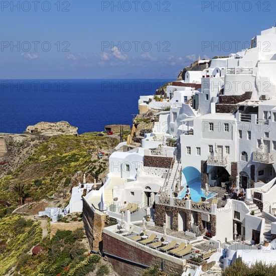White holiday homes on the edge of the caldera overlooking the sea, Oia, Thira, Santorini, Cyclades, Greece