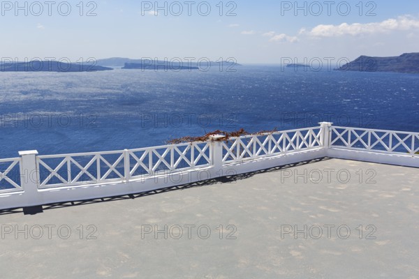 Empty terrace by the sea, view of the caldera, islands on the horizon, Oia, Thira, Santorini, Cyclades, Greece