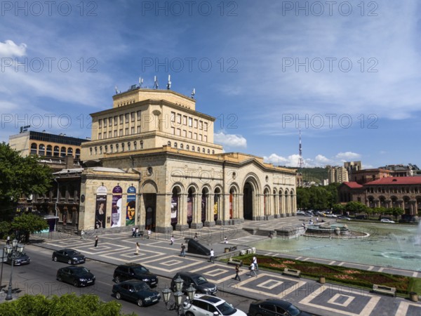 An impressive building dominates the square, flanked by a fountain and urban life, aerial view, History Museum on Republic Square, Yerevan, Yerevan, Armenia