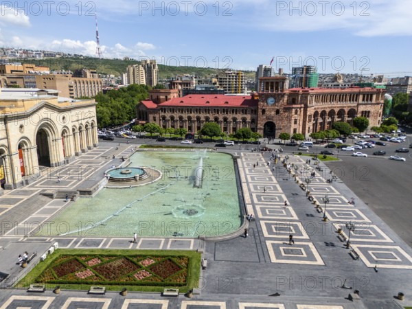 A large square with a fountain surrounded by impressive buildings under a clear sky, aerial view, history museum and government palace on Republic Square, Yerevan, Yerevan, Armenia
