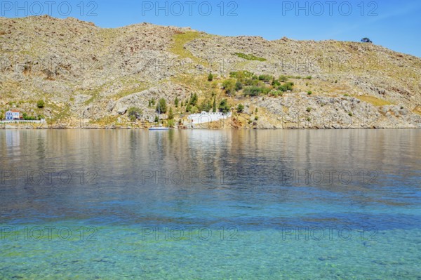 View of the ocean and monastery in the distance from Nimborio Beach, Nimborio, Symi Island, Dodecanese Islands, Greece