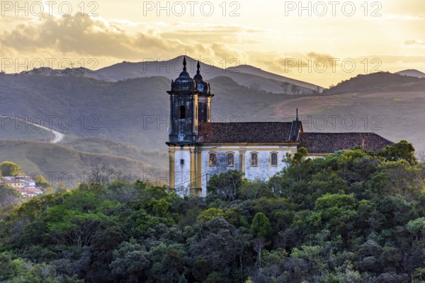 Mountains and baroque church at sunset in the historic city of Ouro Preto in Minas Gerais, Ouro Preto, Minas Gerais, Brazil