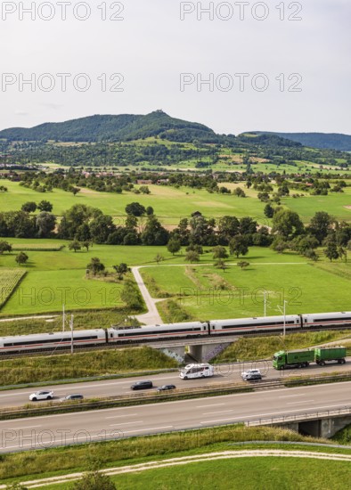 A8 motorway near Kirchheim unter Teck. The route of the new high-speed railway line from Stuttgart to Ulm runs parallel to the road. Deutsche Bahn ICE train. The Swabian Alb with Teck Castle in the background. Kirchheim unter Teck, Baden-Württemberg, Germany