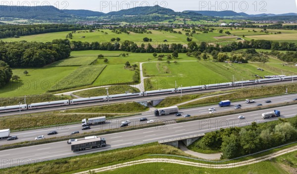 A8 motorway near Kirchheim unter Teck. The route of the new high-speed railway line from Stuttgart to Ulm runs parallel to the road. Deutsche Bahn ICE train. The Swabian Alb with Teck Castle in the background. Kirchheim unter Teck, Baden-Württemberg, Germany