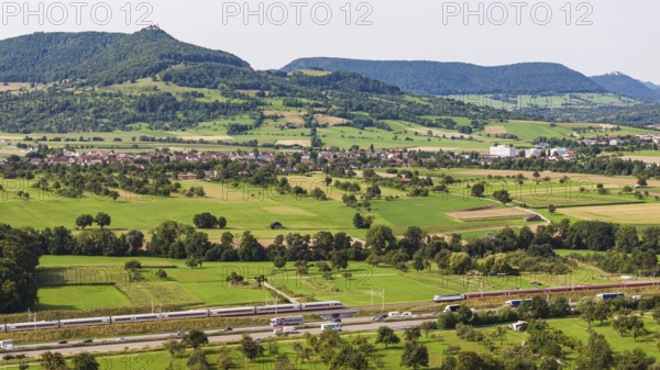 A8 motorway near Kirchheim unter Teck. The route of the new high-speed railway line from Stuttgart to Ulm runs parallel to the road. Deutsche Bahn ICE train and RE200 regional train. The Swabian Alb with Teck Castle in the background. Kirchheim unter Teck, Baden-Württemberg, Germany