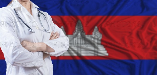 Doctor with crossed arms on Cambodia flag. Cambodia health and care concept. Female doctor on Cambodia flag