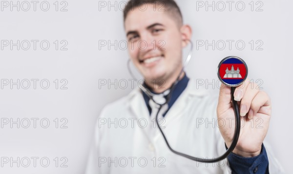 Doctor showing stethoscope with Cambodia flag. Cambodia national healthcare concept