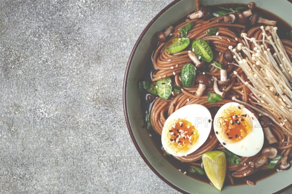 Soba, buckwheat noodles, with enoki mushrooms, shimeji and boiled egg, top view, homemade, no people