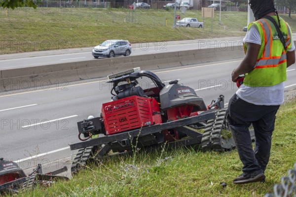 Harper Woods, Michigan, Remote-control mowers are cutting the grass and weeds along Interstate 94 and other freeways running through Detroit. The machines are said to be safer when operating on the steep embankments along most of the city's freeways