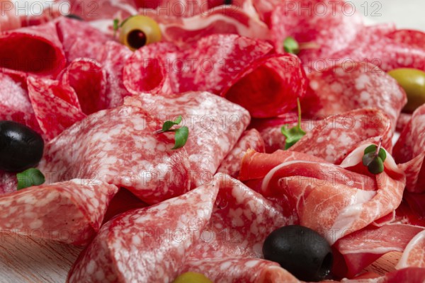 Assorted, meat appetizer, prosciutto, salami and ham, with olives, close-up, breakfast, top view, close-up, without people