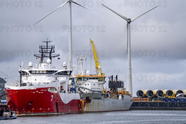 Working vessels in the seaport of Eemshaven, dredger Vitus Bering, aft, cable layer and offshore supply and working vessel Seaway Aimery, Netherlands