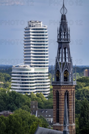 St Joseph's Cathedral Sint Martinusparochie Groningen in the foreground, behind it the tax office building of Groningen, Belastingkantoor, with 2300 workplaces and 25 floors, also here is the Dutch Student Loans Office, Netherlands