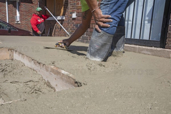 Detroit, Michigan, Workers rebuild front porch of a house they are remodeling in the Morningside neighborhood. The house had been vacant for many years. Detroit lost nearly two-thirds of its residents from 1950 to 2020 but has been growing modestly in recent years