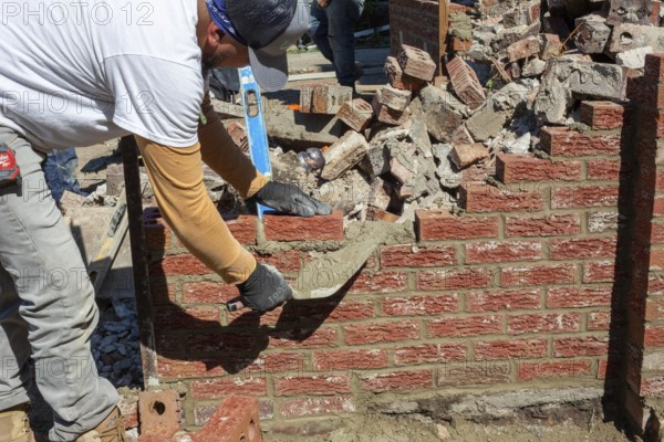 Detroit, Michigan - Workers rebuild the front porch of a house they are remodeling in the Morningside neighborhood. The house had been vacant for many years. Detroit lost nearly two-thirds of its residents from 1950 to 2020 but has been growing modestly in recent years