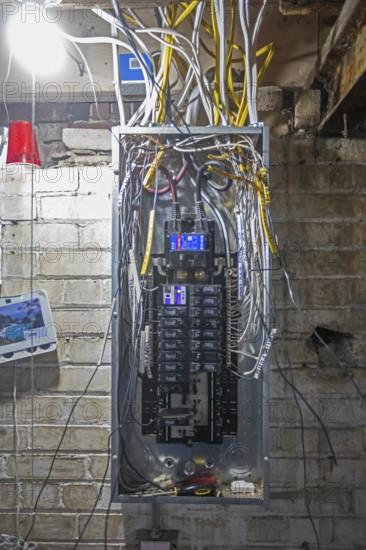 Detroit, Michigan - An electrical panel is wired as workers remodel a house in the Morningside neighborhood. The house had been vacant for many years. Detroit lost nearly two-thirds of its residents from 1950 to 2020 but has been growing modestly in recent years