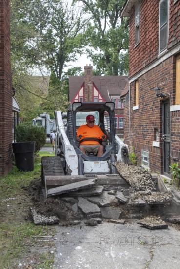 Detroit, Michigan - Workers replace an old driveway, part of remodeling a house in the Morningside neighborhood that had been vacant for many years. Detroit lost nearly two-thirds of its residents from 1950 to 2020 but has been growing modestly in recent years