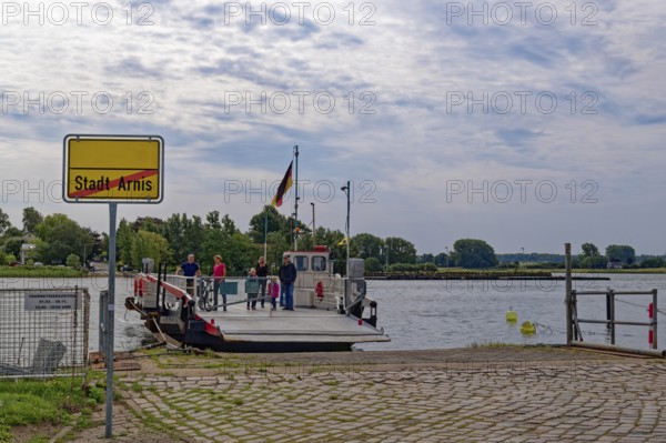Ferry across the Schlei and town sign at the pier of Arnis, the smallest town in Germany. Arnis, Schleswig-Holstein, Germany