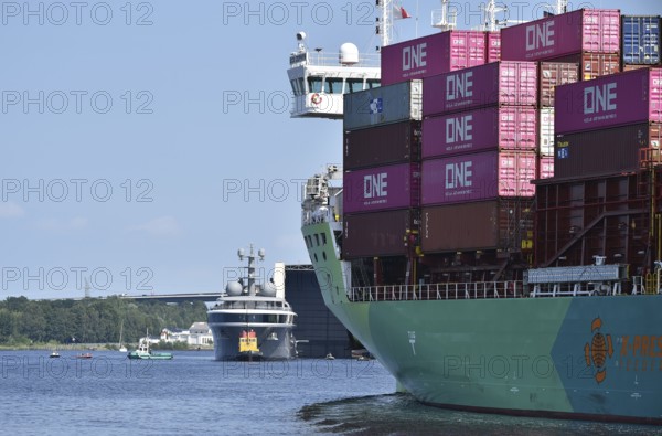 The new superyacht COSMOS and the container ship ECO ZEPHYR meet in the Kiel Canal, Kiel Canal, Kiel Canal, Schleswig-Holstein, Germany