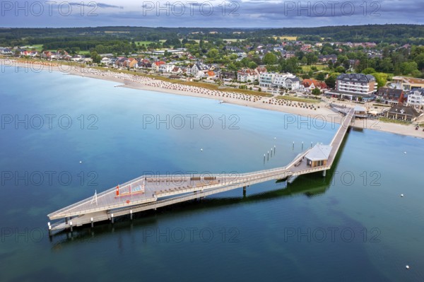 Aerial view over Seebrücke, pier and sandy beach at seaside resort Haffkrug along the Baltic Sea, Scharbeutz, Schleswig-Holstein, Germany