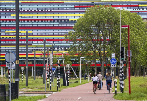 Cycle path through the university campus in Utrecht Science Park, Utrecht University, colourful facade of the Hogeschool Utrecht building, Netherlands
