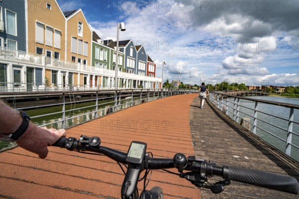 Small town of Houten near Utrecht, bicycles have priority in the town of 50, 000 inhabitants, generous cycle paths, many leisure areas, water areas, living by the water