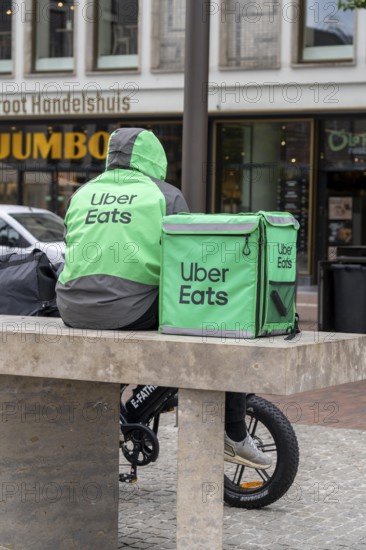 Bicycle transport in Groningen, Uber Eats, courier driver waiting for new orders, with e-bike in moped style, fatbike, Netherlands