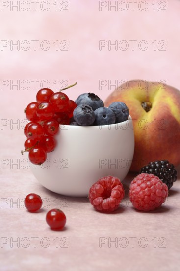 Various fruits in peel, redcurrant, peach, blueberry, blackberry, raspberry