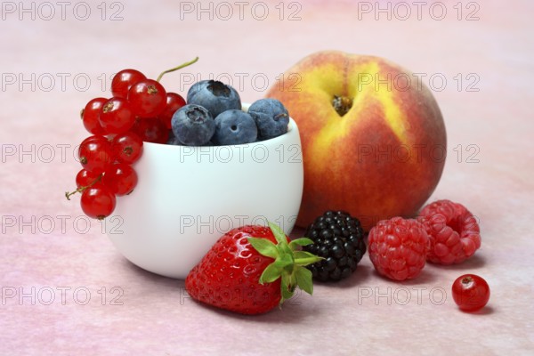 Various fruits in peel, redcurrant, peach, strawberry, blueberry, blackberry, raspberry