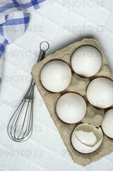 White eggs in packaging with beaters