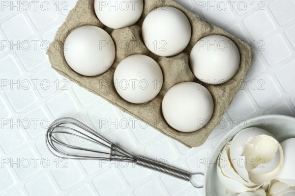 White eggs in packaging with beaters
