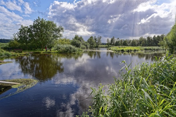 Sun and clouds over the River Trave in Brenner Moor. The Brenner Moor is a salt moor, FFH area, in the Trave lowlands near Bad Oldesloe. Schleswig-Holstein, Germany