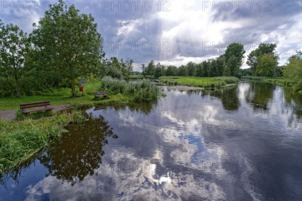 Sun and clouds over the River Trave at a resting place in Brenner Moor. The Brenner Moor is a salt moor, FFH area, in the Trave lowlands near Bad Oldesloe. Schleswig-Holstein, Germany