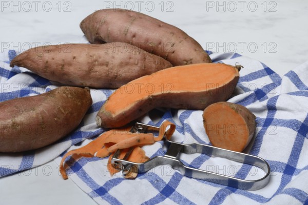 Sweet potatoes with potato peeler, Ipomoea batatas