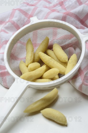 Raw Schupfnudeln in sieve, type of pasta, Germany